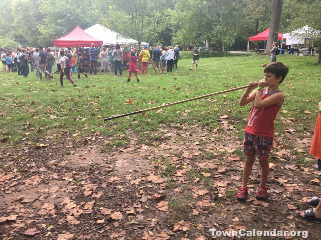 Shooting a blowgun at the annual Native American Festival at Riverbend Park